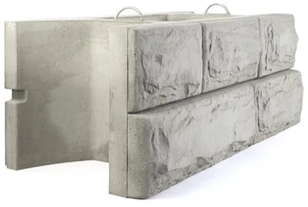 Concrete block with side handles, branded with MCON, designed for easy lifting and transport.