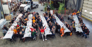 A large group of people from the MCON team seated at tables, engaged in discussion and collaboration.